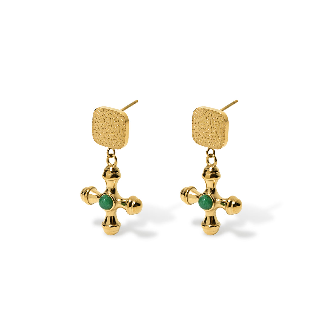 gold dangly earrings with square button top with gold cross pendant that has green stone embedded in the middle of cross