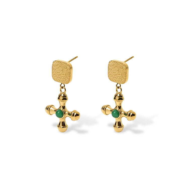 gold dangly earrings with square button top with gold cross pendant that has green stone embedded in the middle of cross