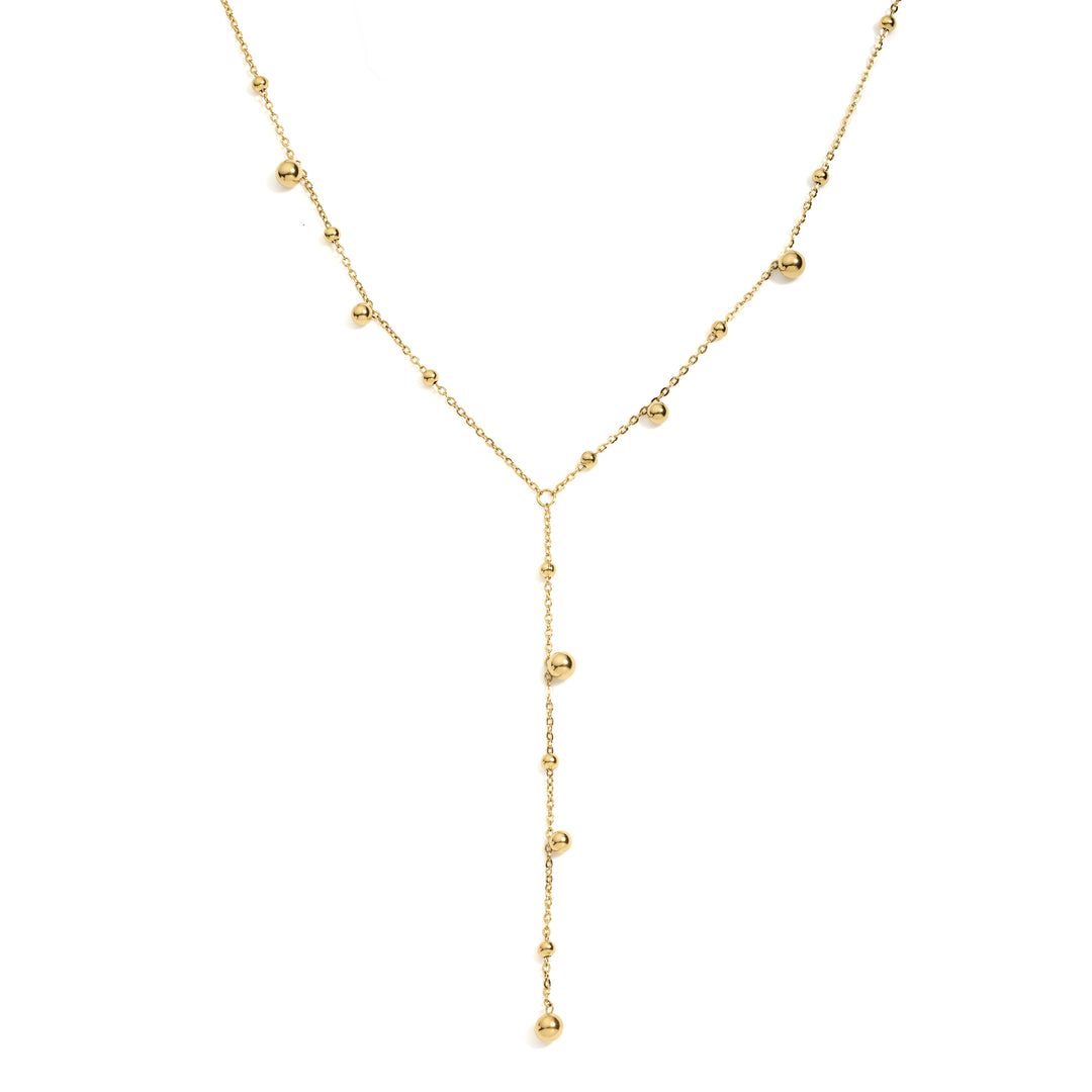 delicate gold chain with gold bead balls scattered on the chain forming a lariat style necklace
