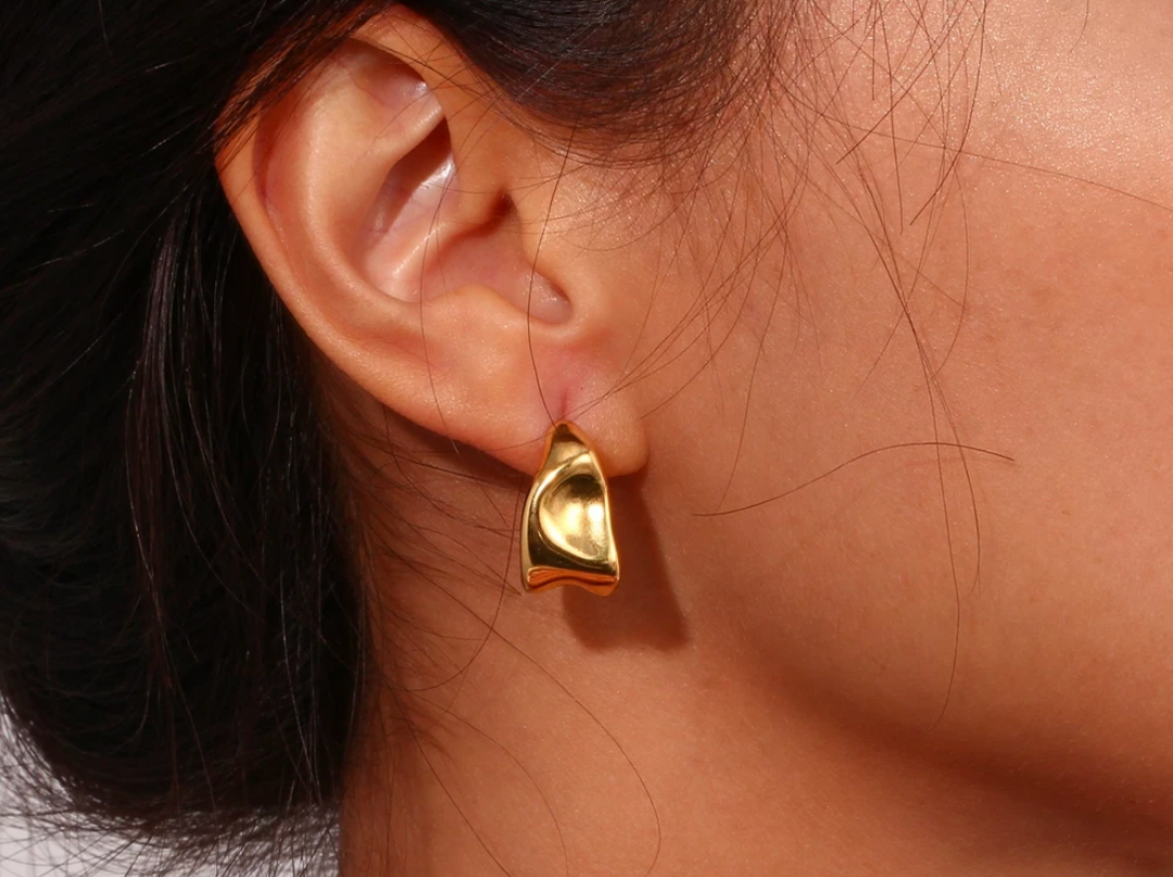 model wearing the gold abstract hoop earring