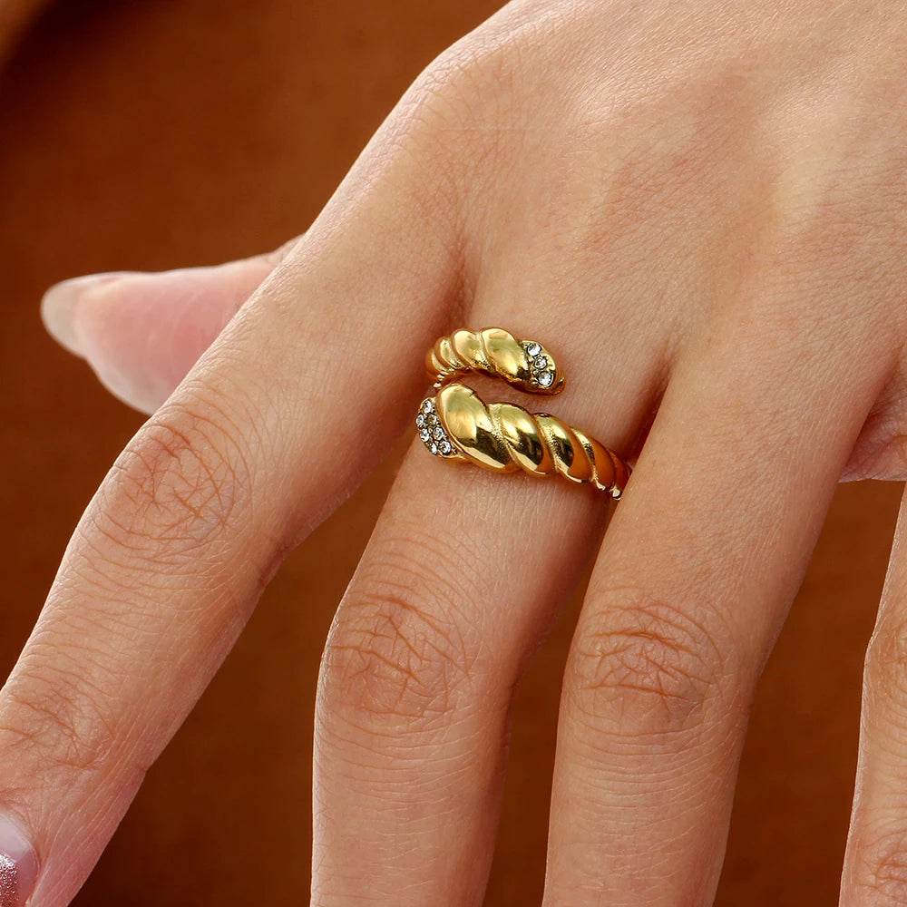 olivia le snake ring worn on a model on her middle finger to show ring