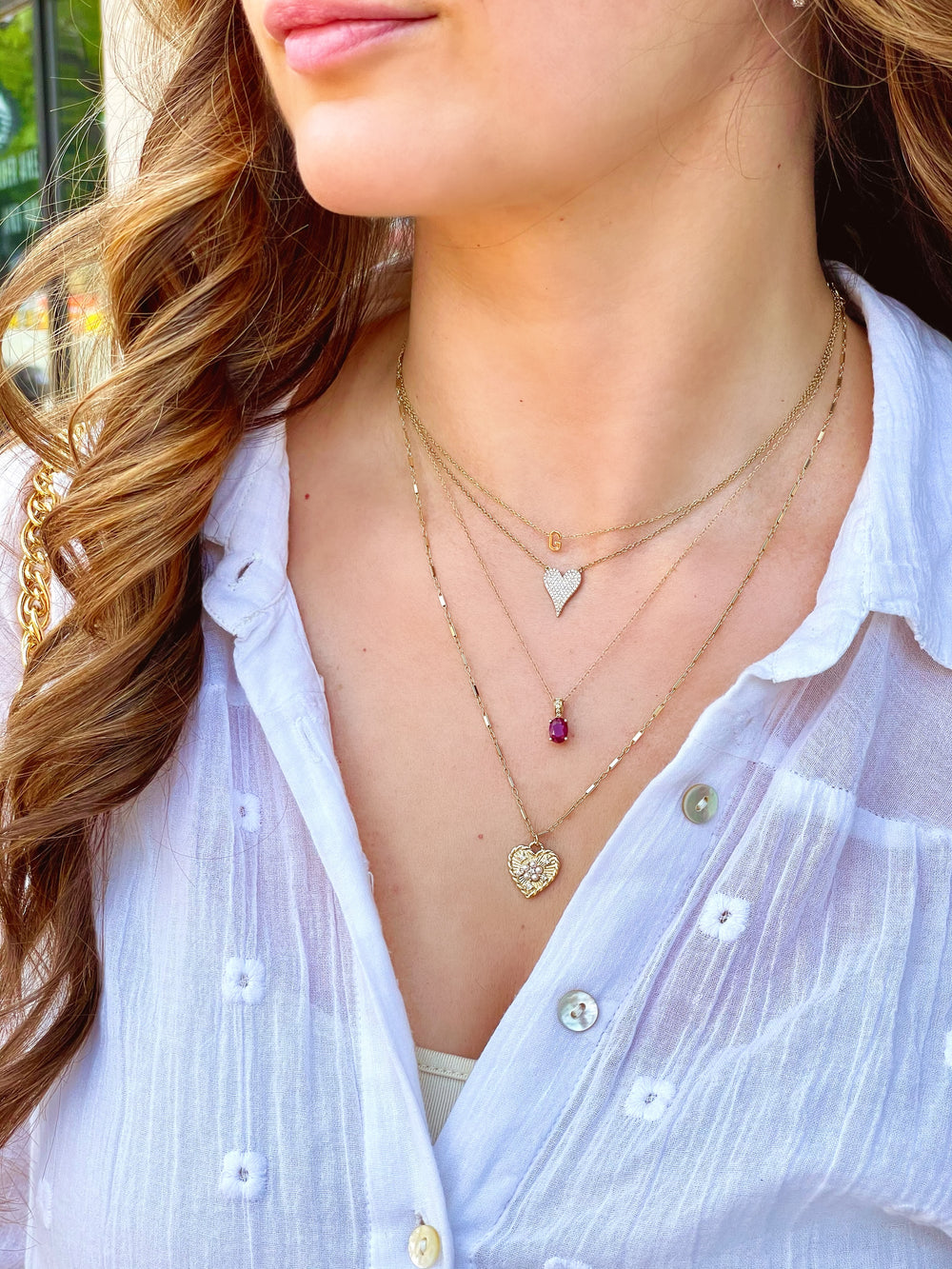 Olivia le model wearing the Bella heart necklace in custom made 20 inch chain layered with other necklaces 
