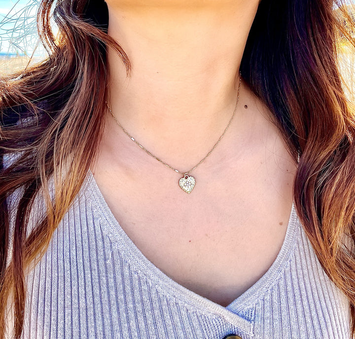 Olivia Le model wearing bella heart necklace on a 16 in chain with a v neck