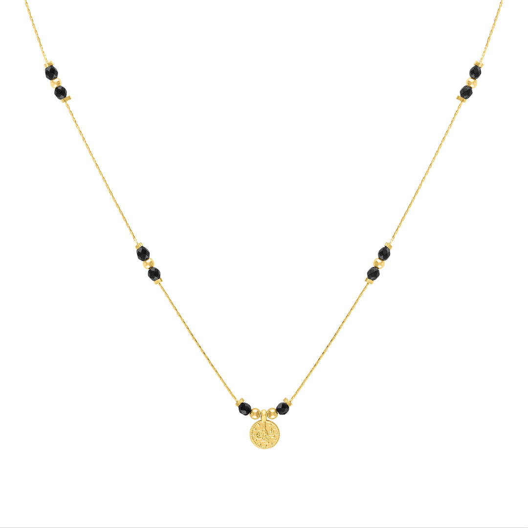 Oliva Le black onyx journey necklace shown as gold filled thin beaded necklace with small black onyx stones and gold filled beads with a turkish coin charm pendant