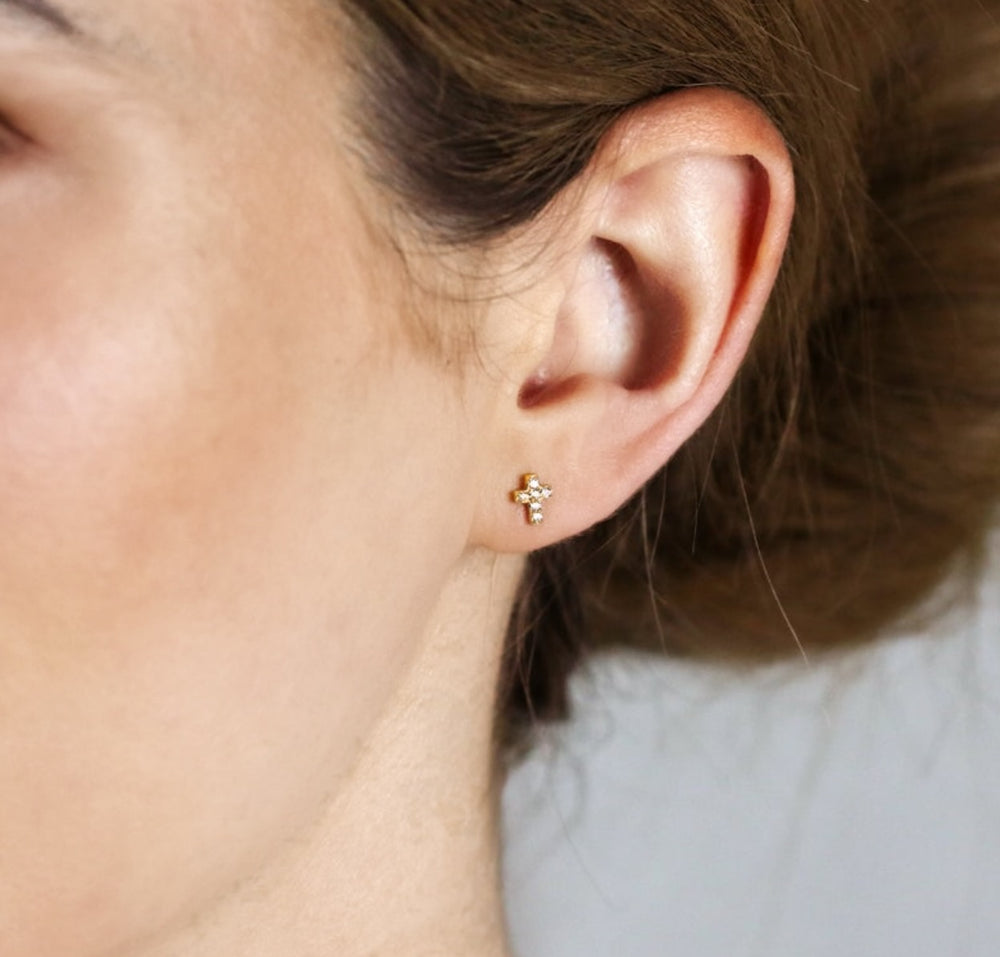 olivia le pave cross stud earrings shown on models ear lobe 