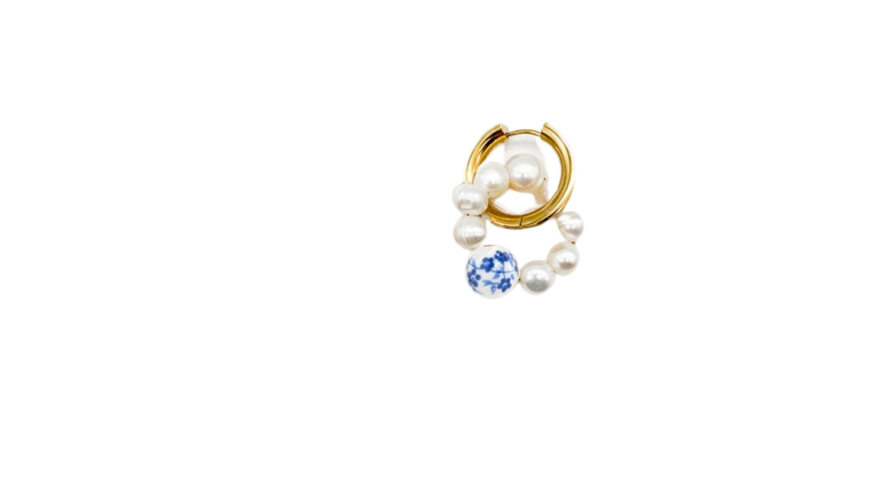 pearl hoop earring with gold hoops and pearl charms dangling with a blue painted bead
