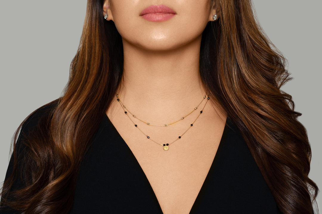 Olivia Le model wearing the Journey Golden Beaded Necklace with black top
