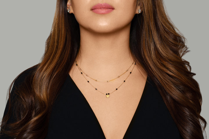 Olivia Le model wearing the Journey Golden Beaded Necklace with black top