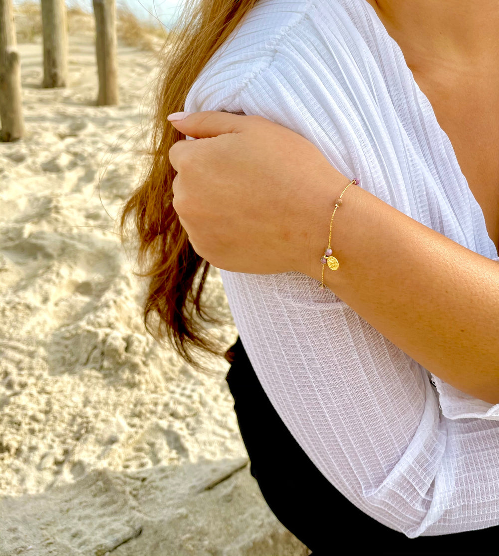 Olivia Le model wearing the Journey Phosphosiderite Beaded Bracelet with Coin pendant and white top