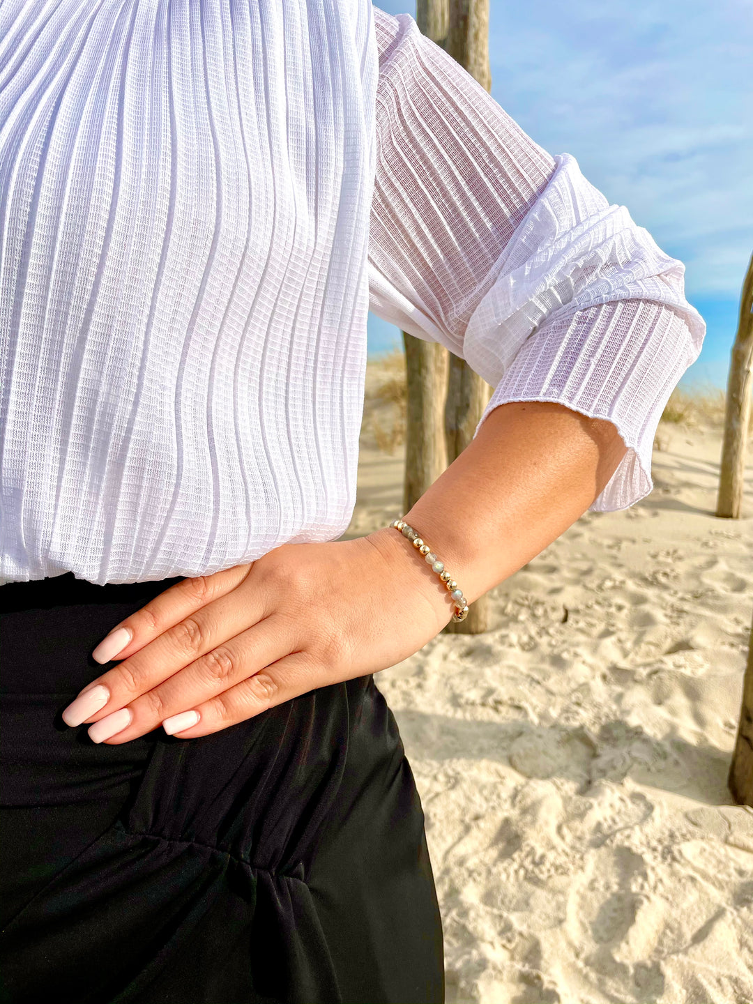Olivia Le model wearing the Labradorite Power Gem Bubble Bracelet with white top