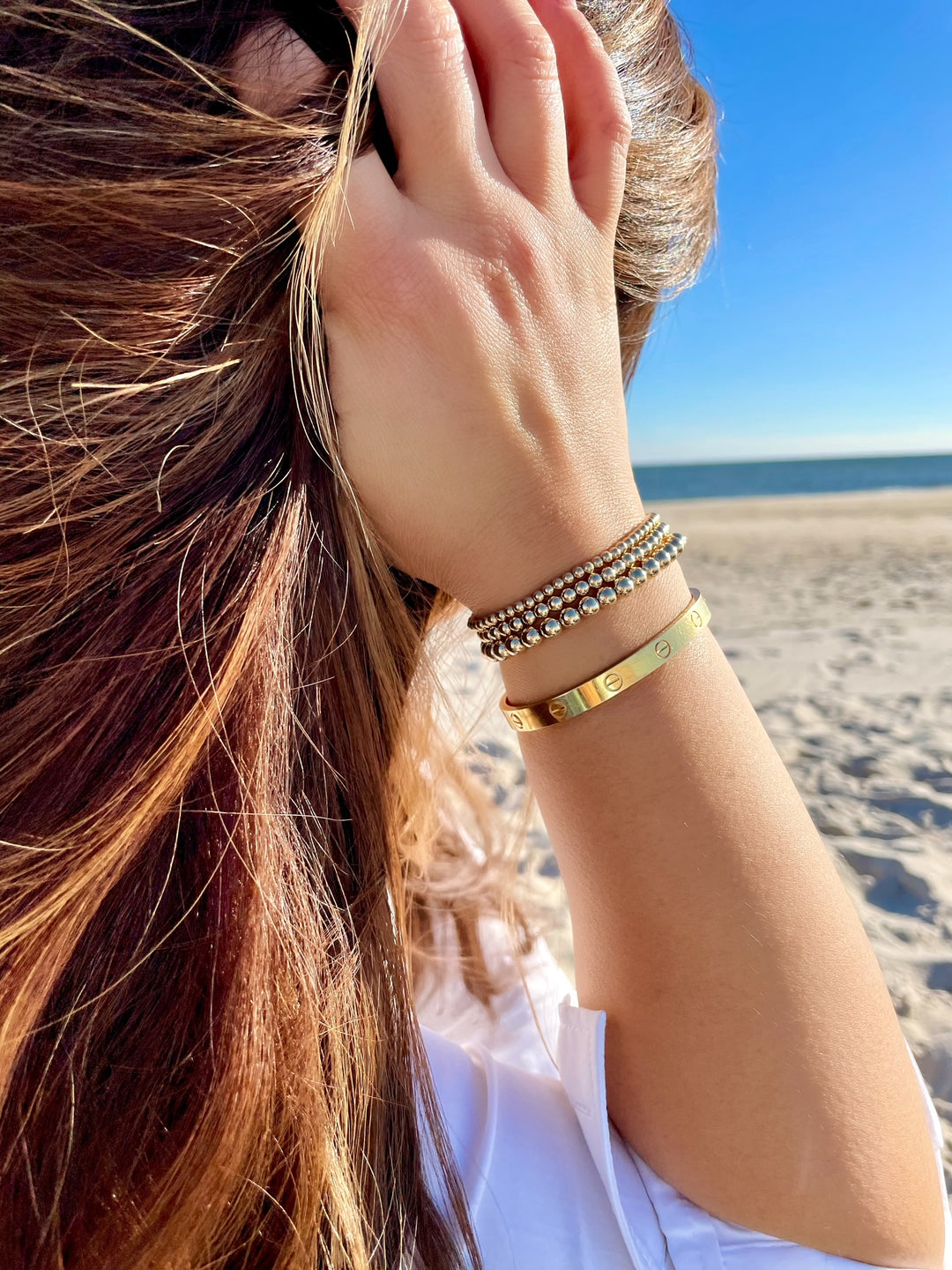 Olivia Le model at the beach wearing a 3MM gold-filled bubble bead bracelet