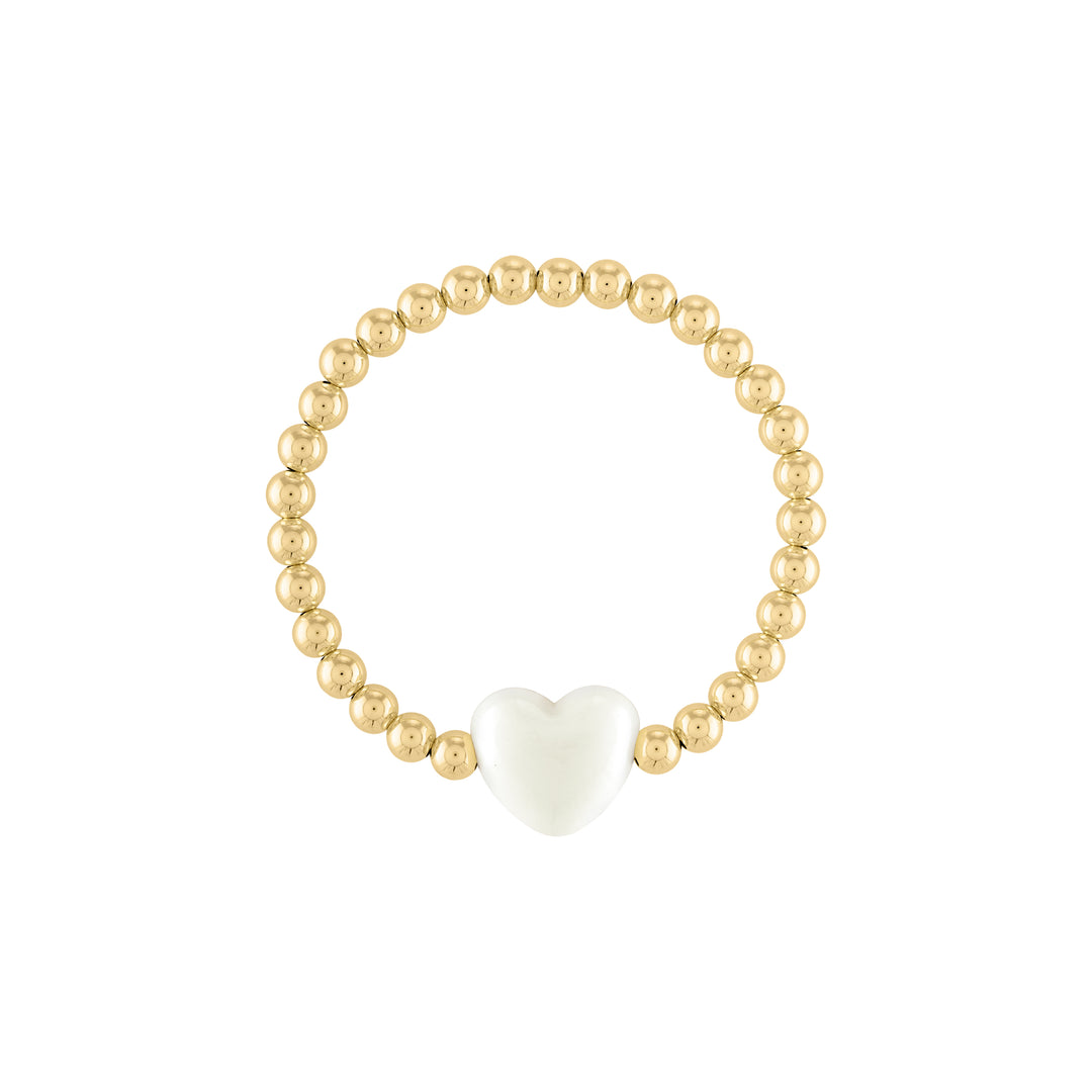 Olivia le love heart bracelet shown with 5mm 14k gold filled round beads with a large ivory puff heart bead charm in the middle on a stretch bracelet 