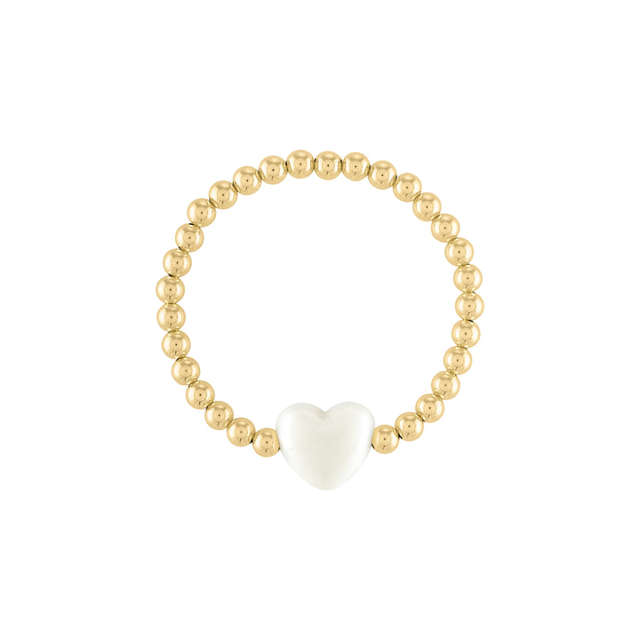 Olivia le love heart bracelet shown with 5mm 14k gold filled round beads with a large ivory puff heart bead charm in the middle on a stretch bracelet 