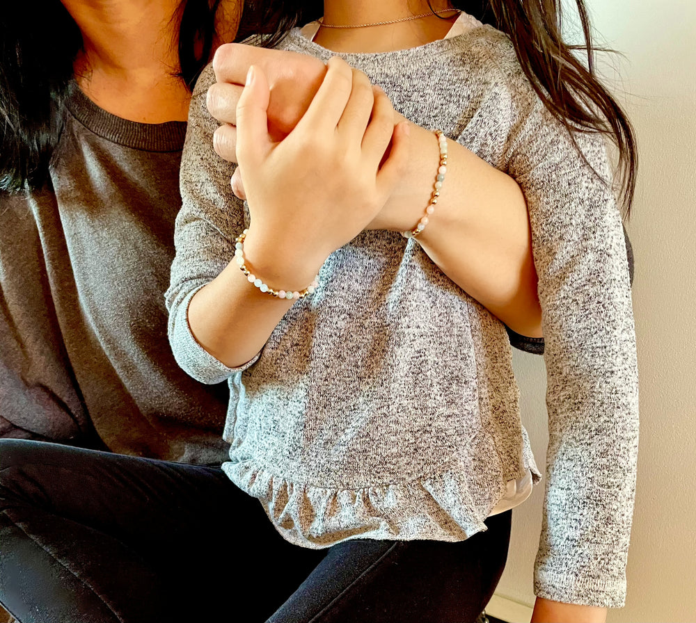 mommy and me wearing matching gemstone beaded bracelets posing together