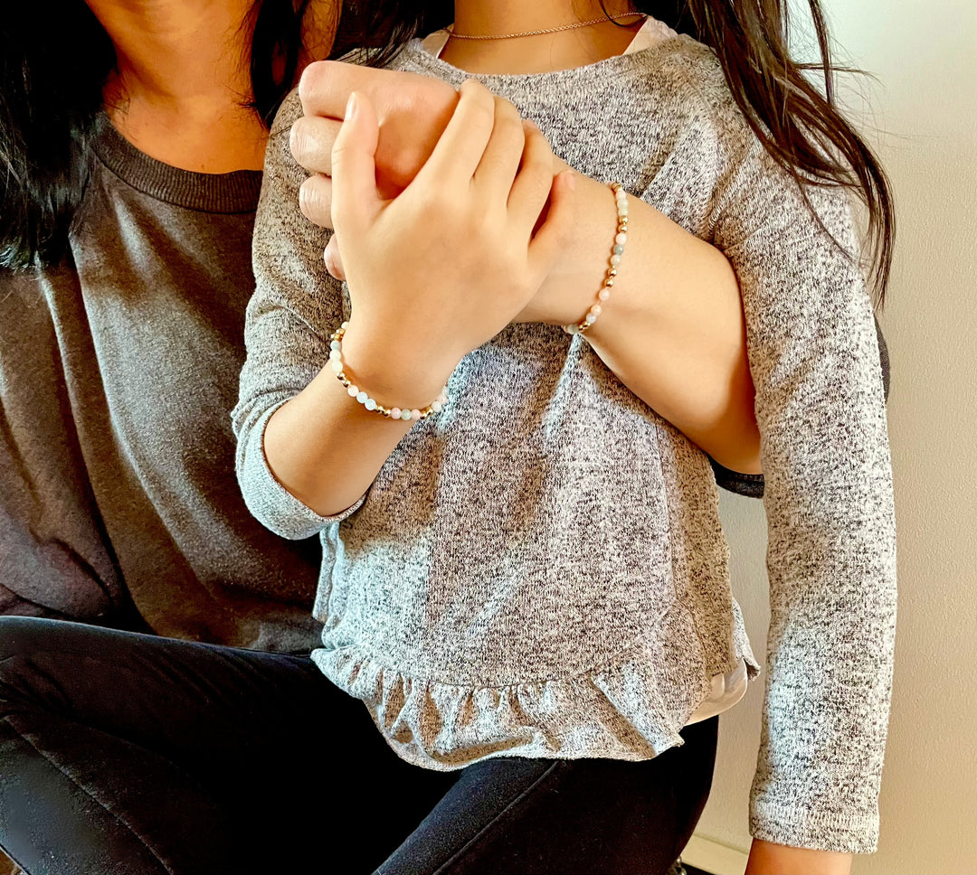 mommy and me wearing matching gemstone beaded bracelets posing together