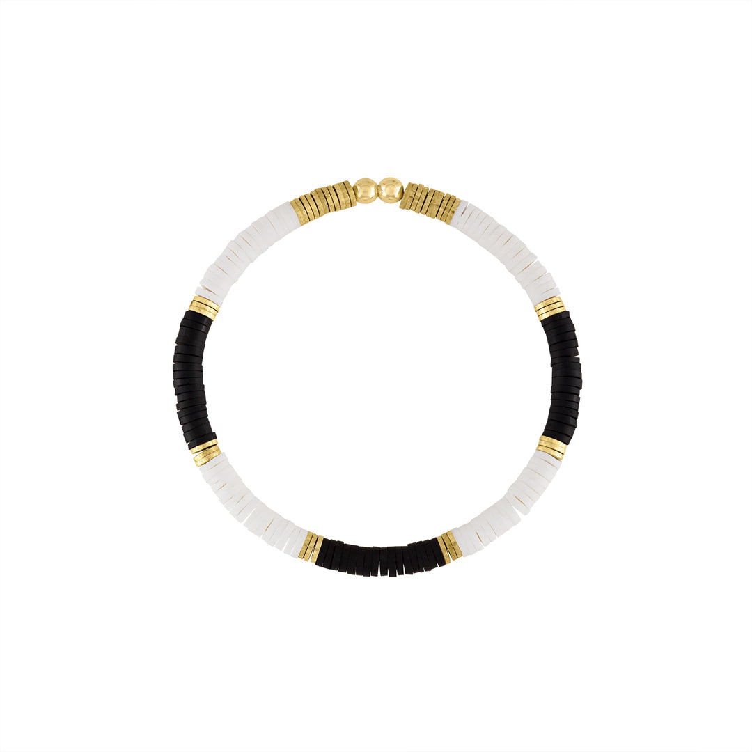 Olivia Le Seychelles bead bracelet features a clean crisp black and white polymer clay bead pattern mixed with gold plated brass discs and 4mm gold filled beads all made on a stretch cord rope for an easy to wear stretch bracelet