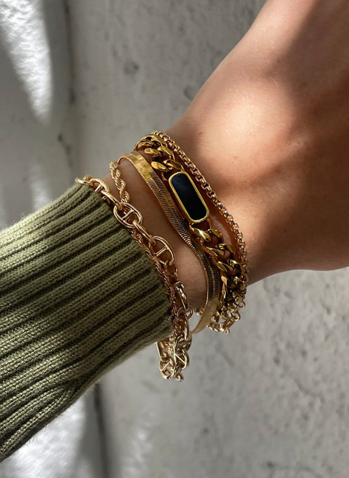 Olivia le tessa gold cuban chain bracelet shown on model with layered bracelets 
