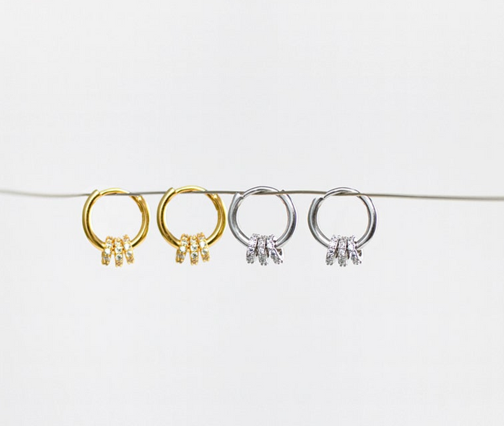 olivia le emma convertible pave hoop earrings shown both gold and silver on a showcase string to show all angles