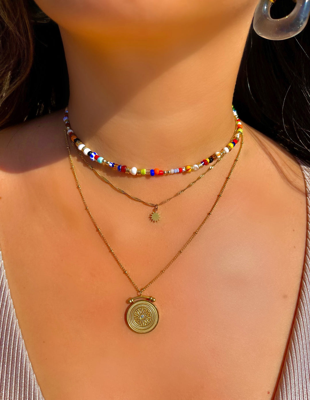 olivia le jetsetter multi beaded necklace that is adjustable on model worn with layered necklaces