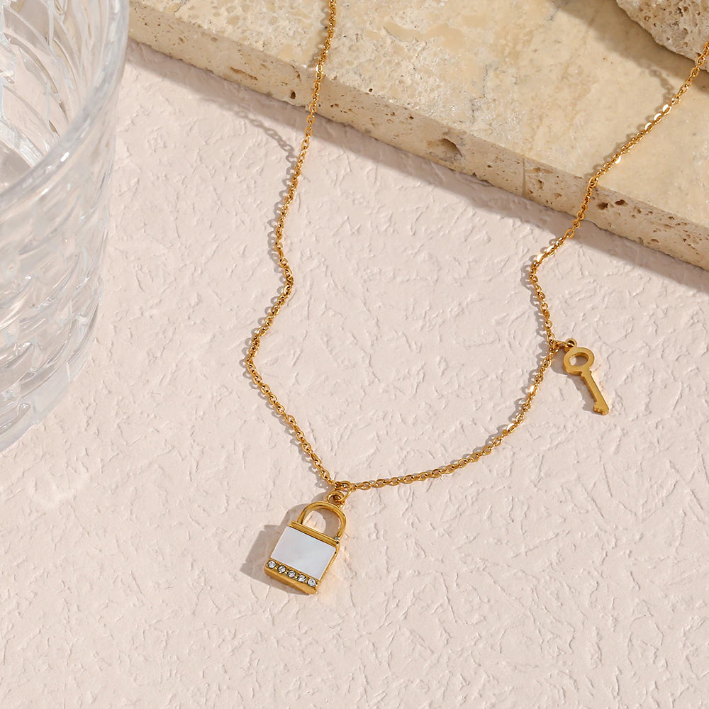 olivia le kora padlock necklace shown in a lifestyle image displayed on stone 