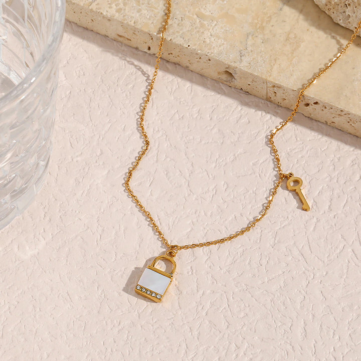 olivia le kora padlock necklace shown in a lifestyle image displayed on stone 