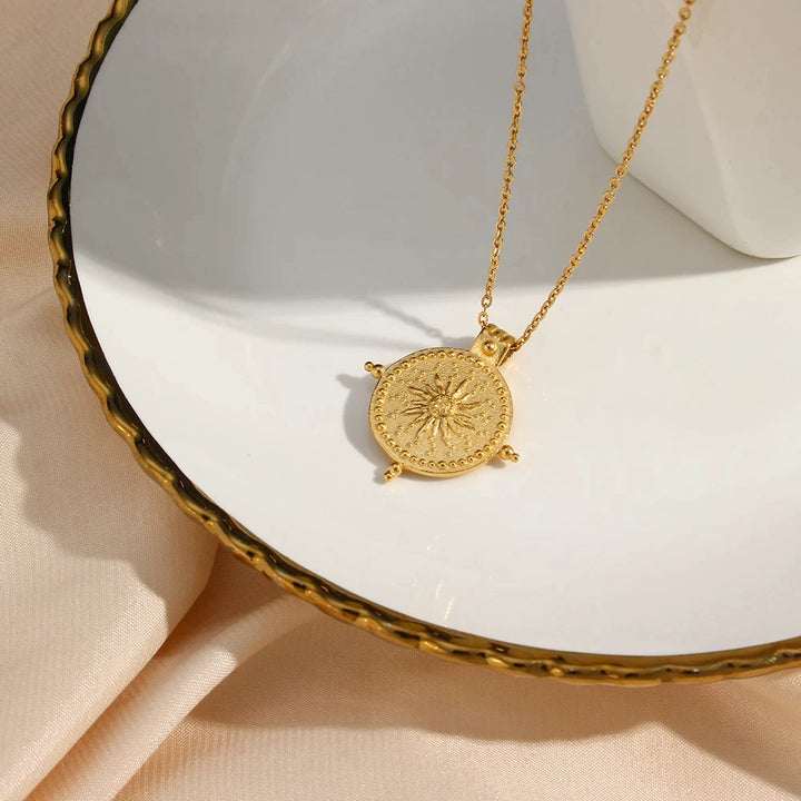 olivia le lifestyle image of the necklace displayed on a white plate with gold decor