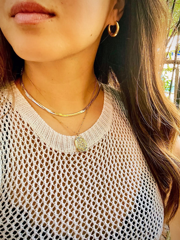 olivia le sahira 2.0 gold chain necklace shown on model wearing with another layered necklace