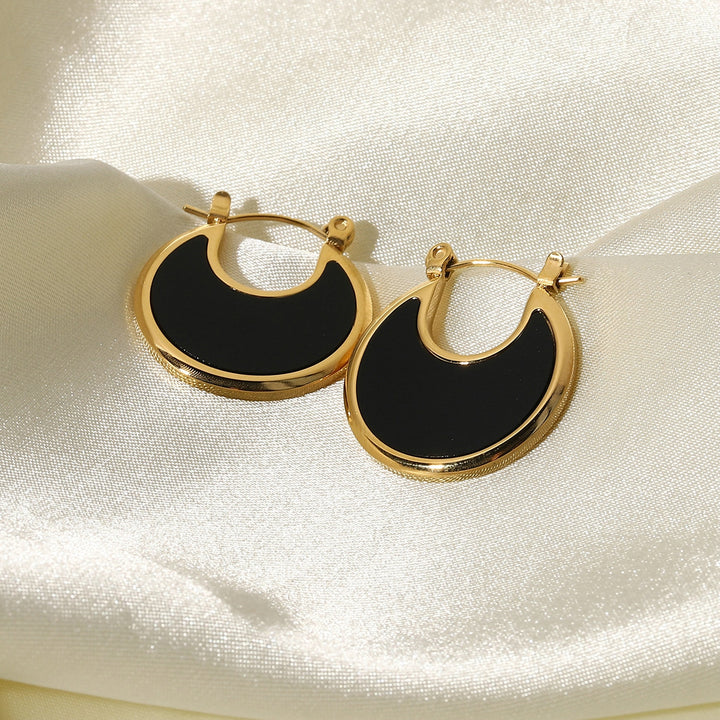 olivia le tessa hoop earrings shown on shiny silk fabric 