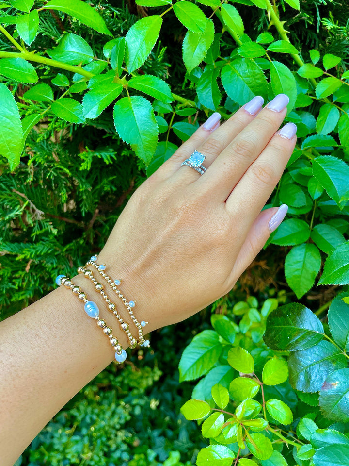 olivia le la perla pearl bracelet shown on models hand gold filled beads mixed with pearls stacked with other bracelets 