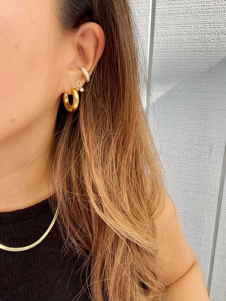 olivia le madison opal studs on models ear shown with hoops and pave ear cuff . madison opal earrings are gold with a opal stone